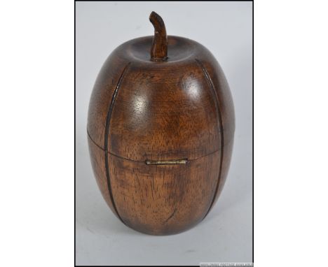 An unusual carved fruitwood tea caddy in the form of a melon having hinged top complete with the key.