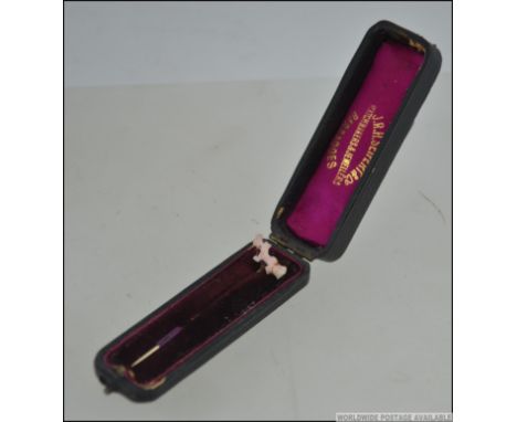 A rare Barbados Colonial Victorian 15ct ( marked ) gold stick pin with pink coral embellished top complete in the presentatio