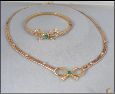 A good 9ct gold diamond and emerald necklace, earrings and bracelet set.

Necklace: An unmarked tested 9ct gold herringbone c