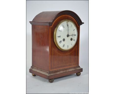 An Edwardian mahogany inlaid 8 day mantel / bracket clock by Goldsmiths & SilverSmiths Ltd, Regent St, London, the 8 day move