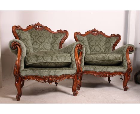 A 20th century cared hardwood sofa settee in the rococo style having carved   show wood frame being well upholstered and rais