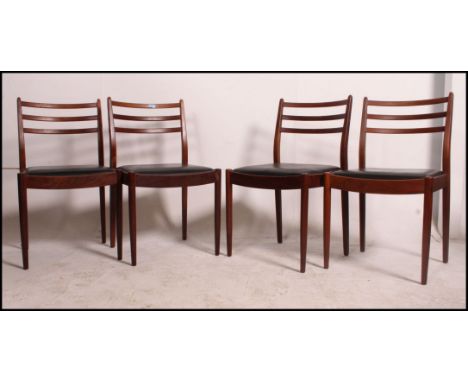 4 vintage mid century G Plan teak dining chairs with black leatherette seat pads .  Measures: 84cm x 49cm x 43cm.