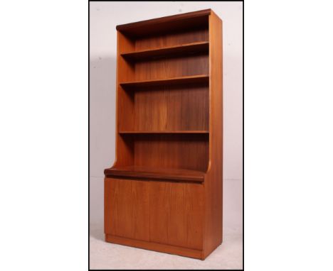 A 1970's retro teak wood Danish influence bookcase / room divider with cupboard under upright shelf back. Measures: 173cms hi