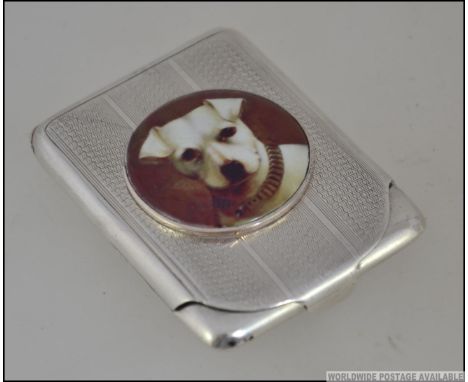 A hallmarked silver card case, with enamel pictorial of a dog to front.  Measures: 7cms long. total weight 38.6g
