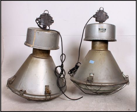A pair of vintage mid century Zaklady Metalow Industrial large factory pendant lights complete with the glass shades and cage