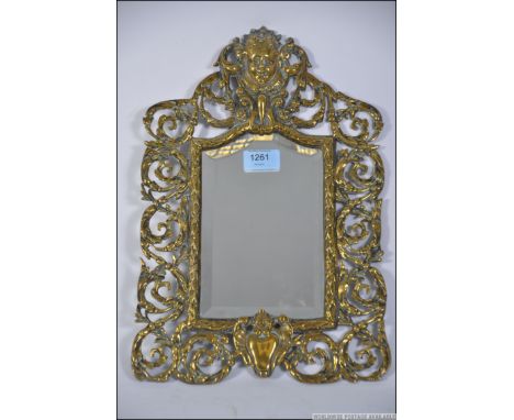 An excellent 19th century Victorian brass rococo wall mirror. The bevelled plate mirror with fret pierced surround with cheru