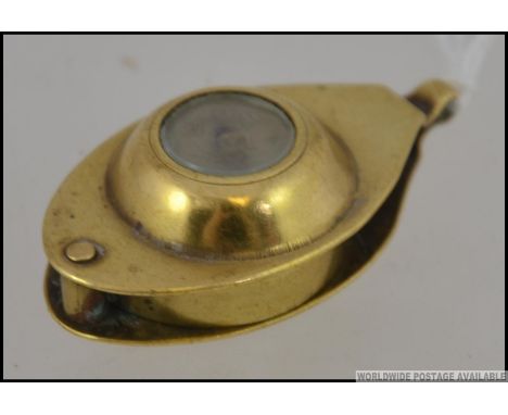 An interesting eye loupe of small proportion . Made of brass with an  inset compass , late 19th / early 20th century