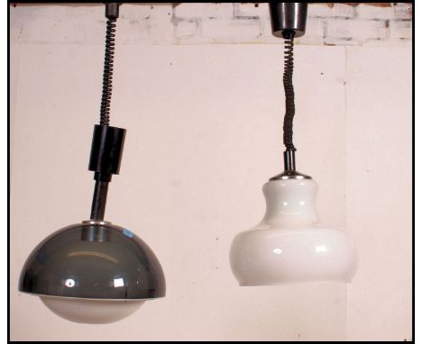 A retro 1970's Lumitron style pendant light shade together with another similar in white milk glass
