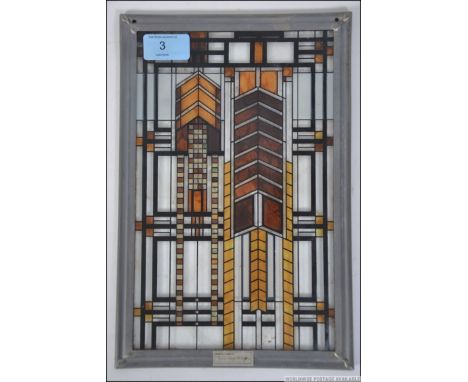 After Frank Lloyd-Wright a geometric coloured glass window hanging in leaded surround having plaque to the base marked Certif
