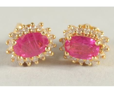 A PAIR OF 18CT YELLOW GOLD, RUBY AND DIAMOND CLUSTER STUD EARRINGS.