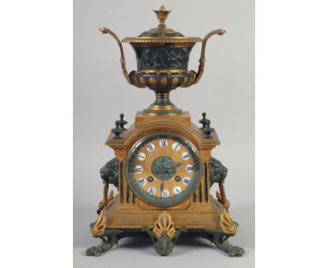 A 19TH CENTURY FRENCH ORMLOU AND GILT METAL CLOCK with urn finial, striking on a single bell, supported on claw feet. 13ins h