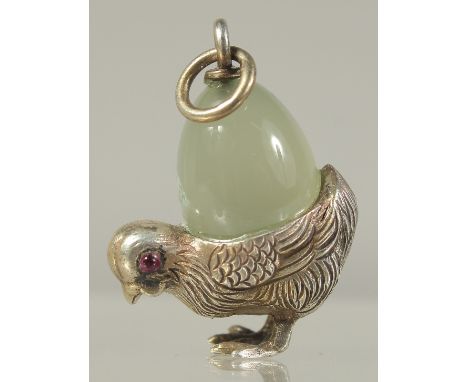 A SILVER AND JADE CHICK PENDANT.