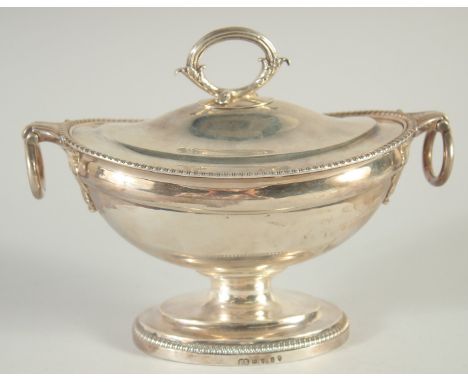 A GEORGE III OVAL SILVER SAUCE TUREEN AND COVER by PAUL STORR with gadrooned edges and ring handles. London 1804.