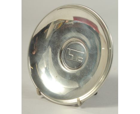 A CARTIER CIRCULAR PEWTER PRESENTATION PLATE. 4.75ins diameter, boxed.