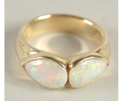 A 9 CARAT GOLD TWO STONE OPAL RING.