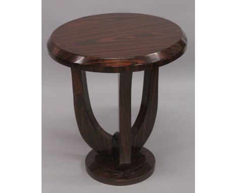 AN ART DECO STYLE ROSEWOOD CIRCULAR TABLE on curving supports. 2ft high x 1ft 9ins diameter.