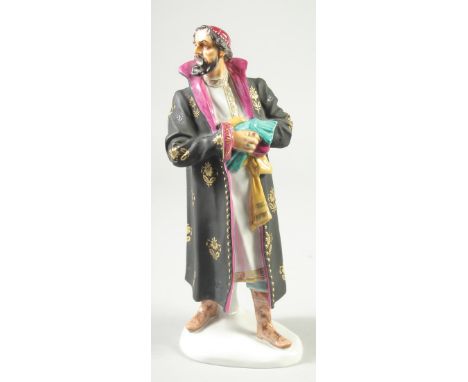 A RARE RUSSIAN PORCELAIN FIGURE OF A BEARDED MAN wearing a long cloak, on a white shaped base. 11ins high.
