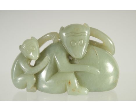 A CHINESE CARVED JADE CARVING OF TWO MONKEYS.  2.75ins.