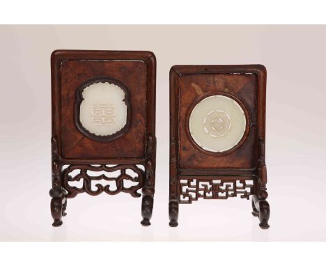 A CHINESE CARVED JADE MEDALLION OF CIRCULAR FORM MOUNTED IN A LATE 19TH CENTURY HARDWOOD TABLE SCREEN, 16cm high; together wi