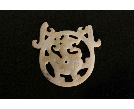 A JADE PENDANT, pierced and carved with a dragon to the centre, of a white colour with green tinge, (a/f). 6.5cm wide