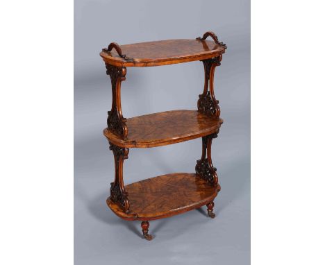 A VICTORIAN BURR WALNUT ETAGERE, CIRCA 1860-70, the three shaped oval tiers with moulded edge and quarter veneers, supported 