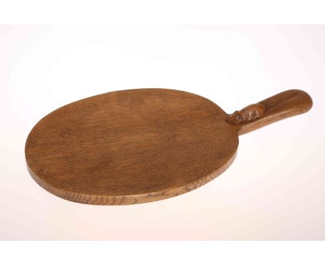 ROBERT THOMPSON OF KILBURN, A MOUSEMAN OAK CHEESEBOARD, of typical oval form with carved mouse signature to the handle. 39.5c