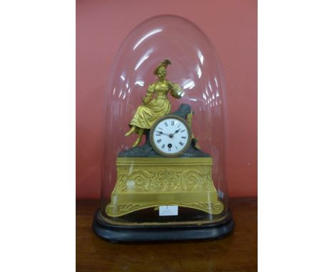A 19th Century French glass domed gilt metal mantle clock, on ebonised stand 