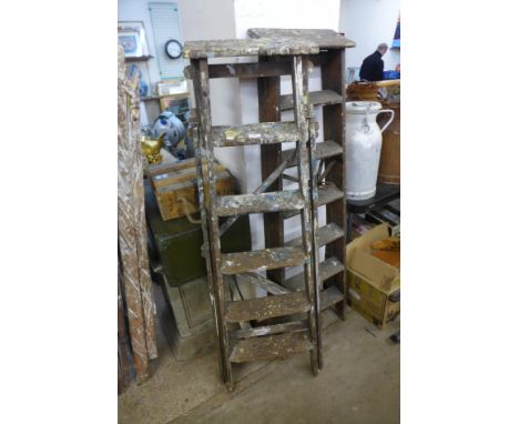 Two sets of stepladders and another ladder 