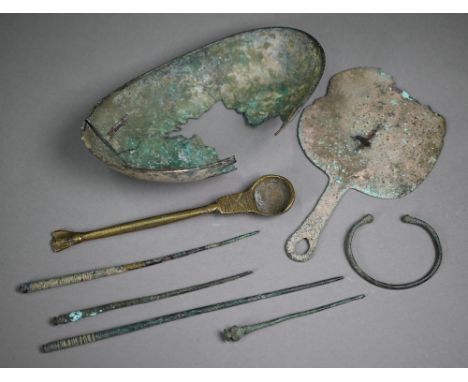 An antiquity copper oval bowl, 9 x 11 cm and a hand-mirror (a/f) to/w a torque bracelet, four bodkins and a reproduction bron
