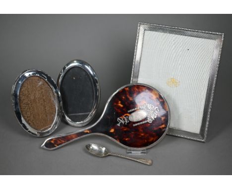 An engine-turned silver photograph frame, Goldsmiths &amp; Silversmiths Co. Ltd., London 1935, 23.5 x 18.5cm, to/w two oval p