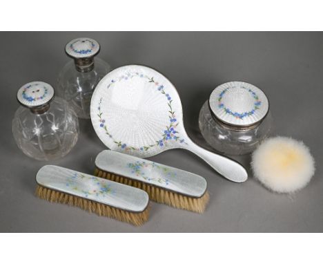 A silver and floral-decorated enamel brush set, London 1927, to/w a matching pair of globular scent bottles and a powder-bowl