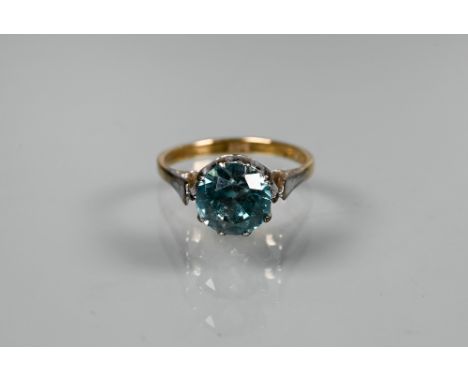 A blue zircon dress ring, the single round stone in high claw setting, yellow and white metal stamped 9ct, size M 