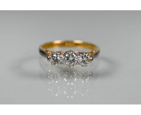 A three stone diamond ring, 18ct yellow gold and platinum set, stamped 16, size L 