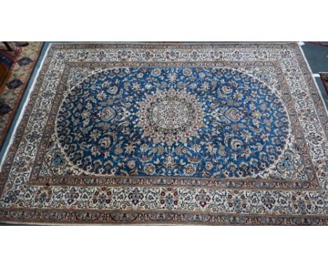 A Central Persian part silk Nain carpet with mid-blue ground centred by radiating floral medallion, 345 x 242 cm 