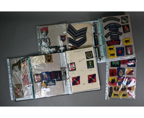 Two folders of British military WWII and other cloth, patch, shoulder titles and other insignia, various regiments/divisions,