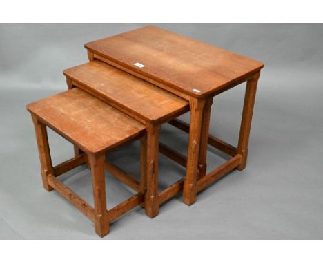 Robert Thompson, Kilburn, a nest of three graduating oak 'Mouseman' coffee tables, each with adzed tops raised on a octagonal