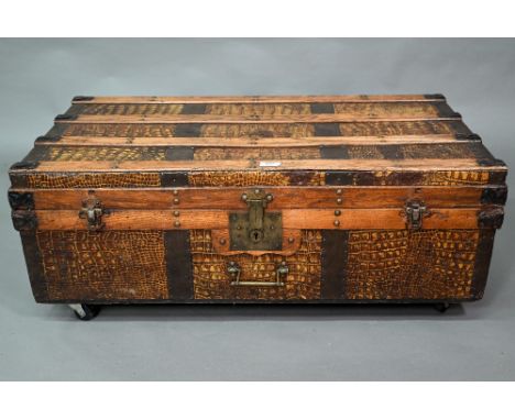 A vintage steel and wood bound crocodile skin panelled trunk, with leather carrying handles, 92 cm w 48 cm x 30 cm h (on late