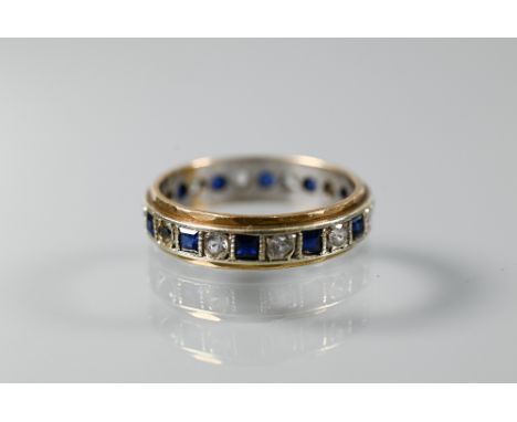 A 9ct yellow and white gold eternity ring set alternate blue sapphires and white stones, size O, approx 3.2g all in 