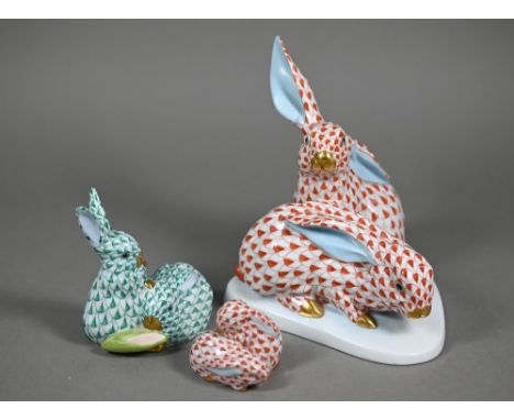 A Herend red-scale group of two rabbits, 15 cm high to/w a smaller green-scale two rabbit group 8.5 cm and a miniature red-sc