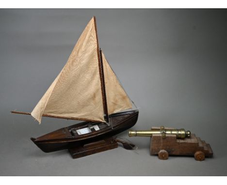 A model sailing dinghy, with card inscribed 'Model of Malay 'Dukone' made by Dick the Malay Pilot, Cocos Keeling Islands 1945