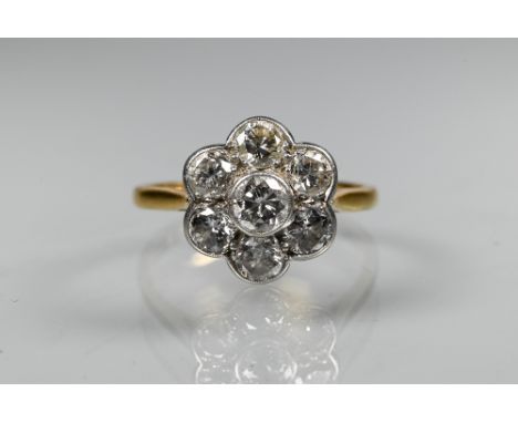 A diamond cluster ring in the form of a flower, millgrain set, stamped 18ct and plat, size P, approx 1.2 cm diam, 3.1g all in