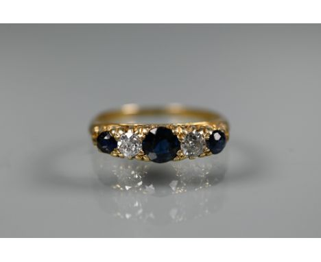 A five stone graduated blue sapphire and diamond ring, 18ct yellow gold set, size M Sapphires with worn facet edges and one w