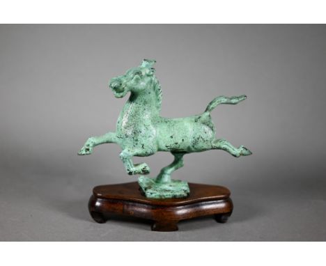 A 20th century Chinese small bronze copy of 'The Flying Horse of Gansu' with applied verdigris finish c/w hardwood stand, 17 