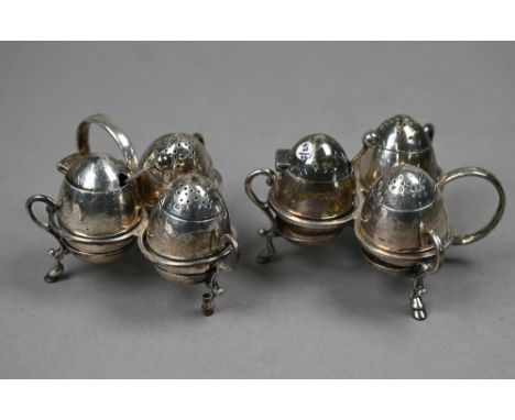 Two Victorian trefoil-frame silver condiment sets with weighted self-righting ovoid salts, peppers and mustards, William Hutt