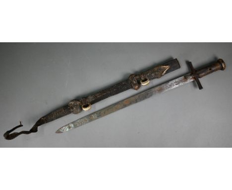 An African Hausa tribal sword, the 53 cm blade with iron crosspiece guard and hide-bound wooden grip and pommel, the scabbard