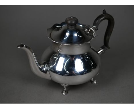 A silver bachelor teapot of pot-bellied form with ebonised finial and handle, on pad feet, Martin, Hall &amp; Co, Sheffield 1