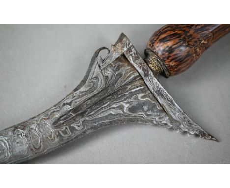 An Indonesian sword Kris with ornate recurved blade, 34 cm, with carved palm-wood grip and scabbard