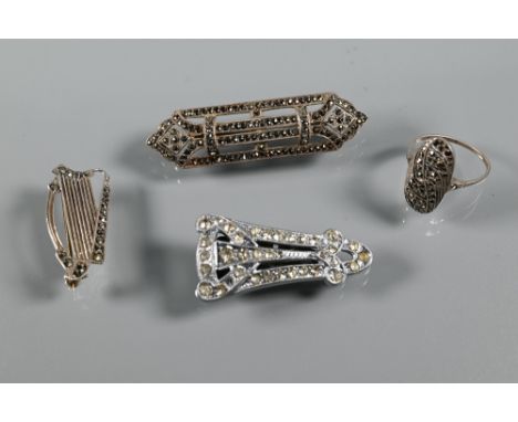 An Irish silver and marcasite brooch in the form of a harp, an Art Deco marcasite brooch, a part dress clip and an Edwardian 