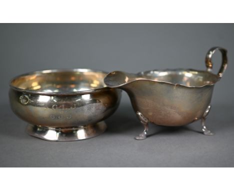 A silver sauce boat on hoof feet, Mappin &amp; Webb, Sheffield 1950, to/w a sugar basin on raised foot-rim, Birmingham 1921 (