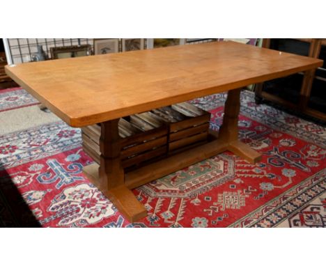 Robert 'Mouseman' Thompson, an oak dining table, the rectangular adzed top raised two large octagonal legs, one carved with s